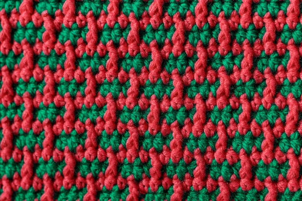 Seamless green pink crochet fabric with brick pattern. Knitted background.