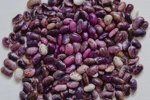 Purple blue scarlet runner beans on a white background.