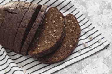 Çizgili tekstil üzerinde koyu kepekli çavdar ekmeği..