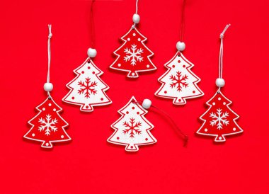 Kırmızı ve beyaz ahşap Noel oyuncakları kırmızı arka planda. Mutlu Noeller ve mutlu yıllar konsepti. Üst görünüm.