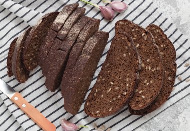 Çizgili peçetenin üzerinde dilimlenmiş çavdar ekmeği. Sağlıklı beslenme konsepti. Üst görünüm.