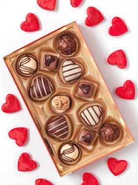 Festive box with chocolate candies and red heart decoration for Valentine's Day.