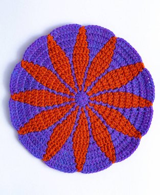 Beyaz arka planda parlak mor turuncu marguerit örgü deseni. Dekor elemanı. Mutfak aletleri ve aksesuarlar. Üst görünüm.