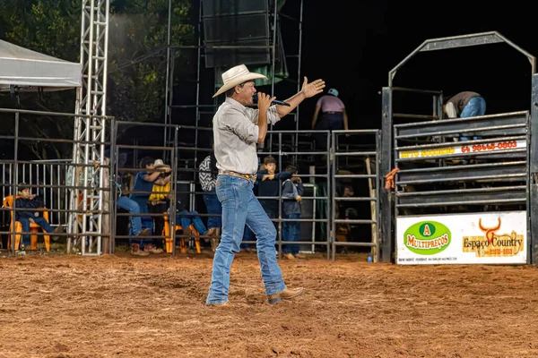 stock image Itaja, Goias, Brazil - 04 22 2023: Person at a bull riding event in a rodeo arena at night