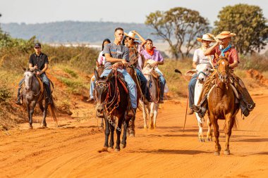 Apore, Goias, Brazil - 05 07 2023: Horseback riding event open to the public on public roads in the Brazilian city of Apore clipart