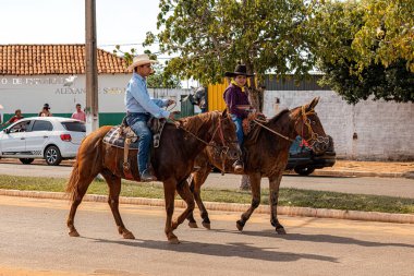 Apore, Goias, Brazil - 05 07 2023: Horseback riding event open to the public on public roads in the Brazilian city of Apore clipart