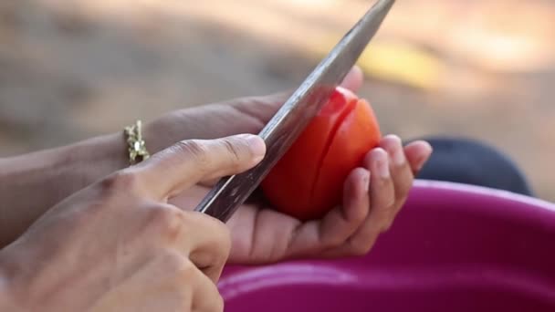 在慢镜头中 一个特写镜头显示双手拿着一把刀在切西红柿 — 图库视频影像