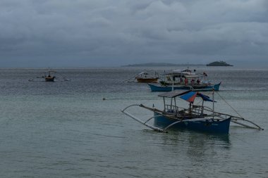 Catamarans on the beach in Siargao Island, Philippines, cloudy day