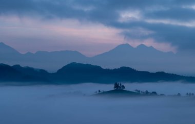 Cerkev Sveti Toma (St. Thomas Church) near kofja Loka, Slovenia. Misty morning and sunrise
