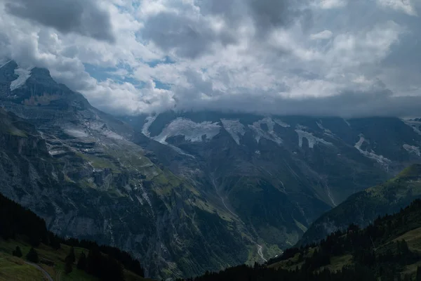 Summer cloudy day in the Swiss alps, mountain landscape, Lauterbrunnen