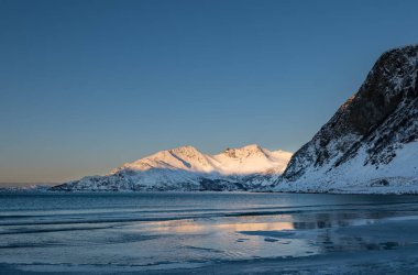 Sunset over the Norwegian fjord, winter photos at the golden hour, Tromso, Norway