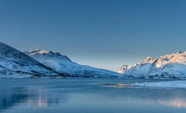 Sunset over the Norwegian fjord, winter photos at the golden hour, Tromso, Norway