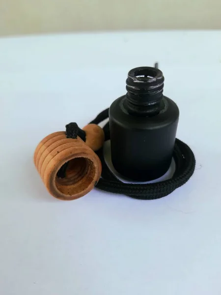 Black Perfume Bottle Made Glass Brown Wooden Cap Black Strap — Stock Photo, Image