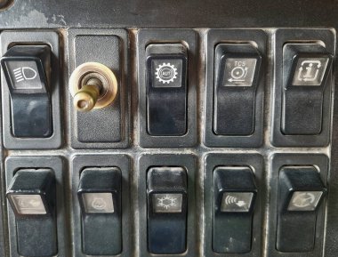 Ağır bir ekipman kamyonunun gösterge panelinde, klima anahtarına odaklanmış bir anahtar var.