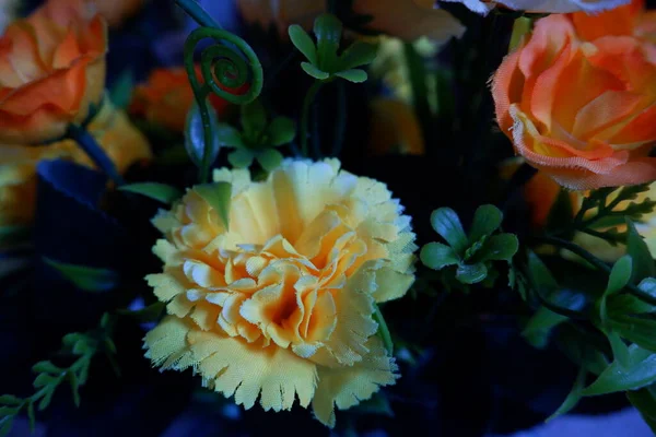 stock image yellow, orange, and white fake flowers composition macro, flowers decoration ornamental background, made from fabric and plastic