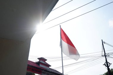 The Red and White flag for Indonesia's independence day with blue sky background