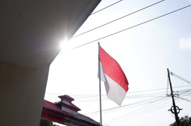 The Red and White flag for Indonesia's independence day with blue sky background