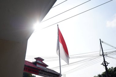 The Red and White flag for Indonesia's independence day with blue sky background