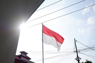 The Red and White flag for Indonesia's independence day with blue sky background