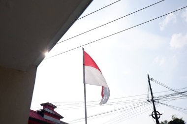 The Red and White flag for Indonesia's independence day with blue sky background