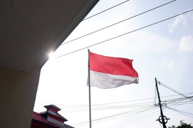 The Red and White flag for Indonesia's independence day with blue sky background