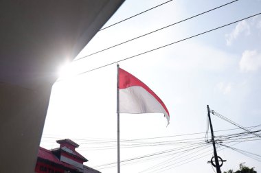 The Red and White flag for Indonesia's independence day with blue sky background