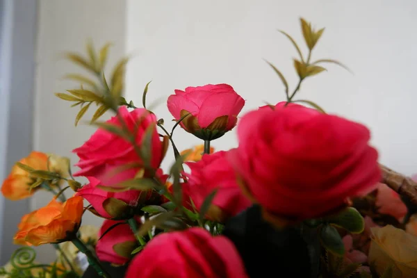 bouquet of red roses fake flowers composition macro, flowers decoration ornamental background, made from fabric and plastic