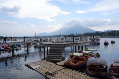 Bagendit Lake tourist attractions with a bamboo boat to play in the middle of the lake.