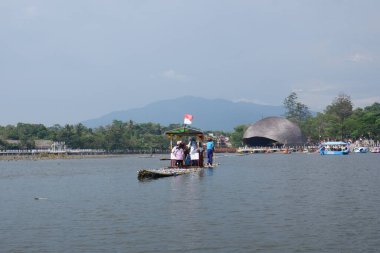 Bagendit Lake tourist attractions with a bamboo boat to play in the middle of the lake.