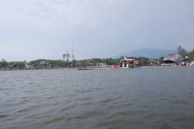 Bagendit Lake tourist attractions with a bamboo boat to play in the middle of the lake.