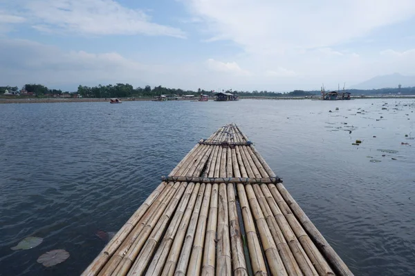 Bagendit Lake tourist attractions with a bamboo boat to play in the middle of the lake.
