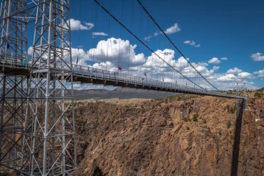 Photograph of the historic and amazing bridge over the Royal Gorge in Fremont County, Colorado that spans the Arkansas River nearly 1,000 feet below making it one of the highest suspension bridges in the world. clipart