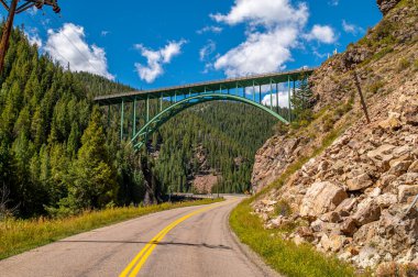 The famous and beautiful Red Cliff Bridge in Colorado along Highway 24 north of Leadville as it crosses Water Street which leads to the small mountain town of Red Cliff. clipart