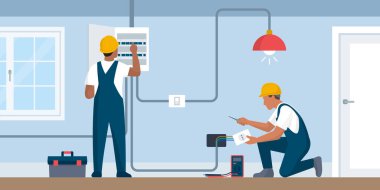 Profesyonel elektrikçiler çalışıyor, elektrik kutusunu kontrol ediyorlar ve bir soket takıyorlar.