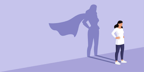 Confident woman standing and looking away, she is casting the shadow of a superhero, confidence and strength concept