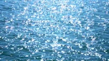 Abstract ambient nautical summer sea sunset and natural background. Calm ocean water. Small breeze waves on water surface motion. Holiday vacation and recreation. Slow motion.