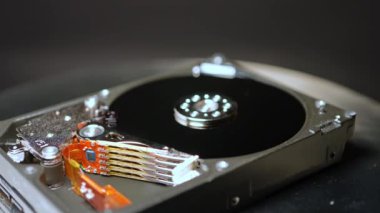 HDD, makro yakın çekim sabit disk rotasyonu, sığ alan derinliği. Bilgisayar sabit sürücüsünün siber güvenlik konsepti. Pc hdd 'yi dahili mekanik ve elektrik parçalarıyla parçalarına ayır.