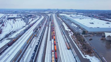 Freight train, laden with cargo along a railway in urban setting. Canadian railway train containers cross-border transportation. Essential delivery: Agincourt North, Ontario, Canada - December 7, 2023 clipart