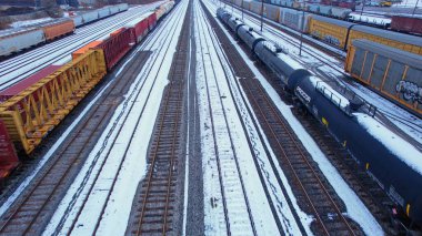 Freight train, laden with cargo along a railway in urban setting. Canadian railway train containers cross-border transportation. Essential delivery: Agincourt North, Ontario, Canada - December 7, 2023 clipart