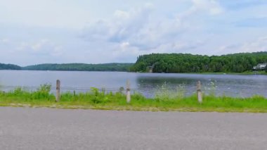 Kanada 'nın kırsal kesimindeki göl manzaralı yan sürücü arabası. Yaz tatili boyunca seyahat ve macera. LED ses, yeşil ekran ve yan projeksiyon için plaka.