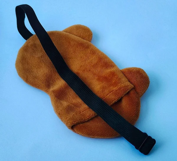 Blindfold or sleep mask with cute brown shape, photo taken from the front angle