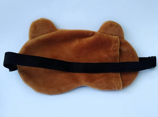 Blindfold or sleep mask with cute brown shape, photo taken from the front angle