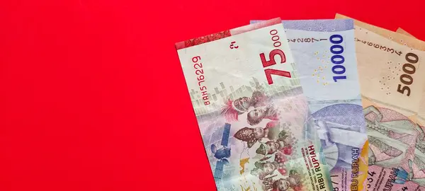 Negative space of new rupiah banknotes isolated on a red background