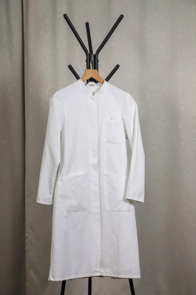 white coat and stethoscope on a hanger