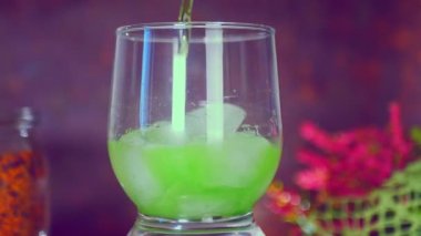 I pour a green drink into a glass of water 4k Cinematic