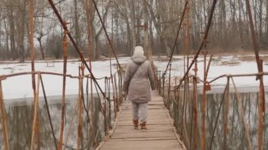 A woman walks across the bridge alone seclusion Cinematic