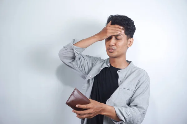 stock image Unhappy and surprised people looking into an empty wallet. the concept of not yet paid and old date. Man with financial problems