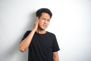 Kulağı ağrıyan adam ağrıyan kulak, vücut ağrısı konseptini tutuyor.