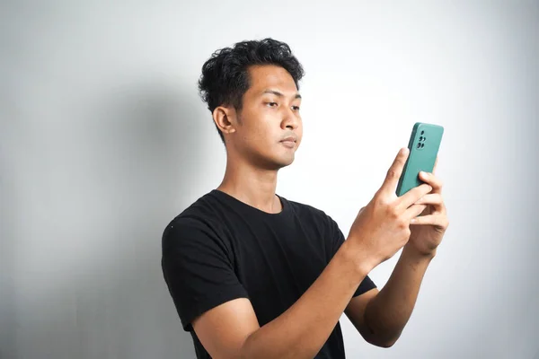 Asian Man Seriously Concentrated Smartphone Isolated White Background — Φωτογραφία Αρχείου