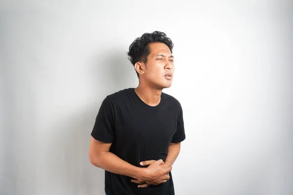 Pria Asia Memiliki Sakit Perut Pada Latar Belakang Abu Abu — Stok Foto